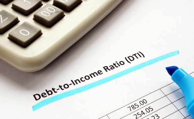 Máy tính và bảng số liệu tỷ lệ nợ trên thu nhập (DTI) với bút dạ quang màu xanh.
